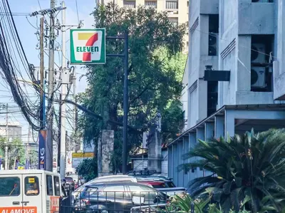 a sign on a pole on a city street with cars at 1BR Condotel Suite at Sunshine100 City Plaza #SS03 in Manila