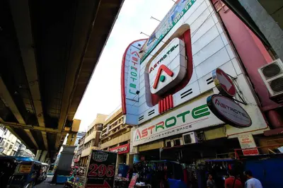 a group of signs on the side of a building at Astrotel Avenida in Manila