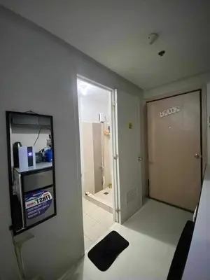 a room with a room with a door and a bathroom at Khencob's Pad Quezon City in Manila