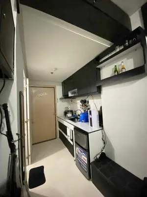 a small kitchen with a sink and a stove at Khencob's Pad Quezon City in Manila