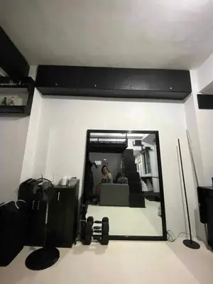 a mirror in a living room with a person in the reflection at Khencob's Pad Quezon City in Manila