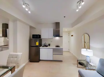 a kitchen with a refrigerator and a counter top at 1BR Condotel at Azure Urban Resort Near Airport #AZ03 in Manila