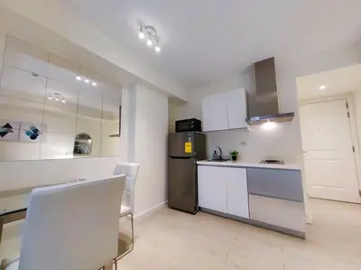 a kitchen with white cabinets and a stainless steel refrigerator at 1BR Condotel at Azure Urban Resort Near Airport #AZ03 in Manila