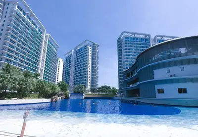 a large swimming pool in front of tall buildings at 1BR Condotel at Azure Urban Resort Near Airport #AZ01 in Manila
