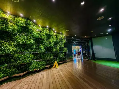 a room with a green wall filled with plants at 1BR Condotel at Azure Urban Resort Near Airport #AZ01 in Manila