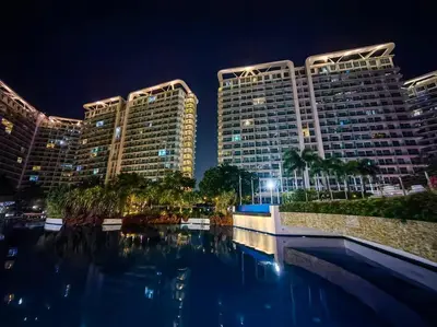 a view of two tall buildings at night at 1BR Condotel at Azure Urban Resort Near Airport #AZ01 in Manila