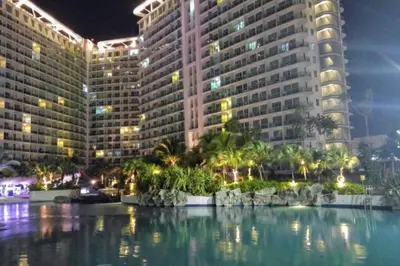 a view of two large buildings at night at 1BR Condotel at Azure Urban Resort Near Airport #AZ01 in Manila