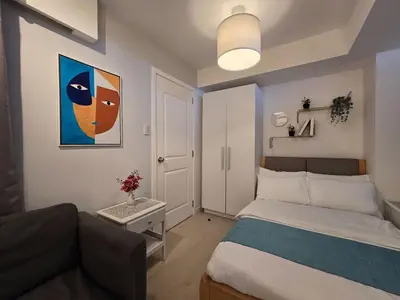 a small bedroom with a bed and a couch at 1BR Condotel at Azure Urban Resort Near Airport #AZ04 in Manila