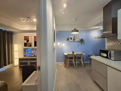 a kitchen and living room with a table in it at 1BR Condotel at Azure Urban Resort Near Airport #AZ04 in Manila