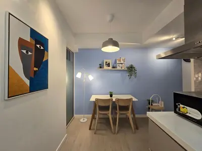 a kitchen with a table and a painting on the wall at 1BR Condotel at Azure Urban Resort Near Airport #AZ04 in Manila