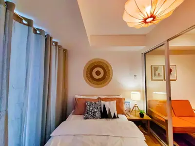 a bedroom with a bed and a mirror at 1BR Condotel at Azure Urban Resort Near Airport #AZ02 in Manila