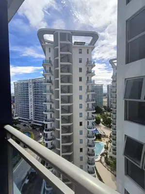 a view of a tall building from a balcony at 1BR Condotel at Azure Urban Resort Near Airport #AZ02 in Manila