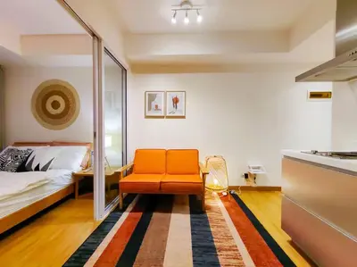 a bedroom with an orange chair and a bed at 1BR Condotel at Azure Urban Resort Near Airport #AZ02 in Manila