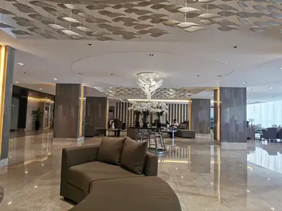 a lobby with a couch in the middle of a building at Shore 3 residence mall 'of Asia in Manila