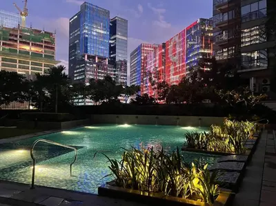 a swimming pool in a city with tall buildings at Elegant 1 BR Condo with Balcony in Uptown Parksuites II, BGC in Manila