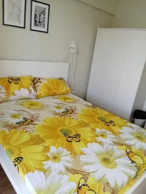 a bed with yellow and white flowers on it at Asteria Lovely Staycation in Manila