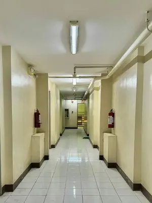 an empty hallway in an office building with a light at Serenity Acqua Inn Beside Enchanted Kingdom in Santa Rosa