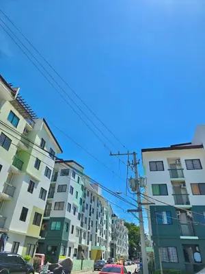 a group of buildings on a city street at Serenity Acqua Inn Beside Enchanted Kingdom in Santa Rosa