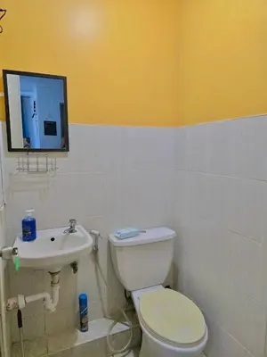 a bathroom with a toilet and a sink at Serenity Acqua Inn Beside Enchanted Kingdom in Santa Rosa