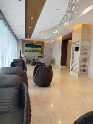 a living room with couches and chairs in a building at Cozy 642 shore3 residence tower2 near MOA in Manila