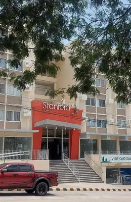 a red truck parked in front of a building at STANFORD SUITES 3 in Silang