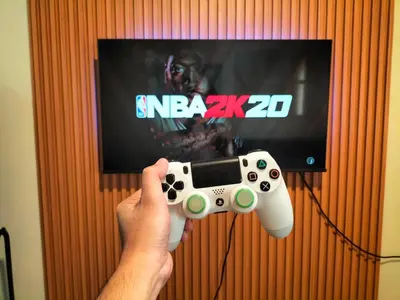 a person holding a video game controller in front of a tv at STANFORD SUITES 3 in Silang