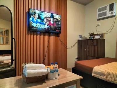 a room with a bed and a tv on a wall at STANFORD SUITES 3 in Silang