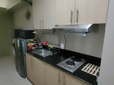 a small kitchen with a sink and a refrigerator at Comfy unit at SMDC Breeze Residences near PICC, MOA, NAIA Airport, CCP with a view! in Manila