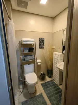 a small bathroom with a toilet and a sink at Comfy unit at SMDC Breeze Residences near PICC, MOA, NAIA Airport, CCP with a view! in Manila