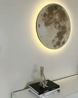 a clock on a wall with a doll sitting on a book at Relax in style: Modern Airbnb and Netflix in Manila