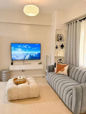 a living room with a couch and a flat screen tv at Relax in style: Modern Airbnb and Netflix in Manila
