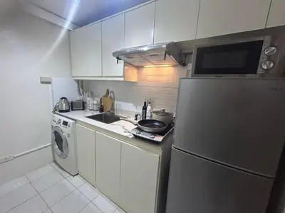 a kitchen with a stainless steel refrigerator and a sink at Relax in style: Modern Airbnb and Netflix in Manila