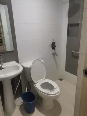 a bathroom with a white toilet and a sink at Hotel Sogo Alabang Southroad in Manila