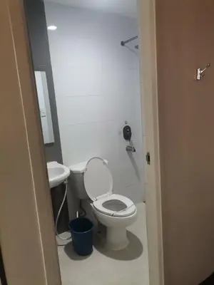 a bathroom with a toilet and a sink at Hotel Sogo Alabang Southroad in Manila