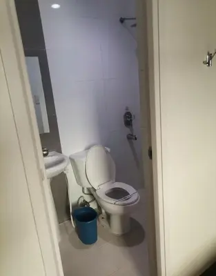 a small bathroom with a toilet and a sink at Hotel Sogo Alabang Southroad in Manila