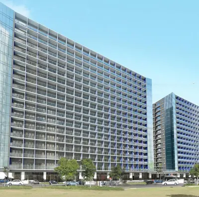 a large office building with a lot of windows at Cozy 1-bedroom unit in Shore 3 Residences in Manila