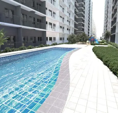 a large swimming pool in front of a building at Cozy 1-bedroom unit in Shore 3 Residences in Manila
