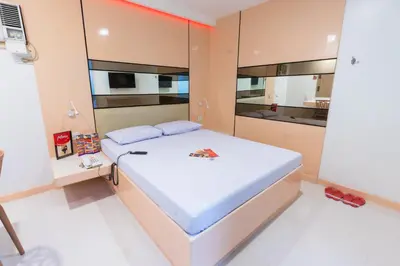 a small bedroom with a bed with a white mattress at Hotel Sogo Guadalupe in Manila