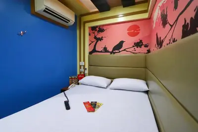 a bed in a small room with at Hotel Sogo Makati Avenue in Manila