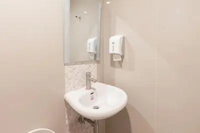 a bathroom with a white sink and a mirror at Hotel Sogo Cainta in Manila