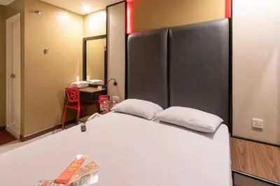 a bedroom with a bed with two pillows on it at Hotel Sogo Cainta in Manila