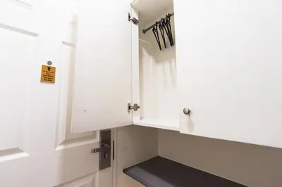 a kitchen with white cabinets and a sink at Hotel Sogo Cainta in Manila