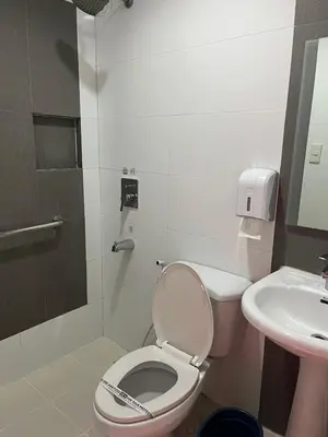 a bathroom with a toilet and a sink at Hotel Sogo Quirino in Manila