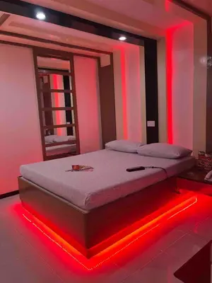 a bedroom with a bed with red lights on it at Hotel Sogo Quirino in Manila
