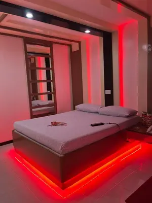 a bed in a room with red lights on it at Hotel Sogo Quirino in Manila