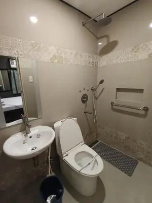 a bathroom with a toilet and a sink at Hotel Sogo Quirino in Manila