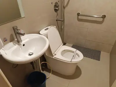 a bathroom with a white toilet and a sink at Hotel Sogo Quirino in Manila