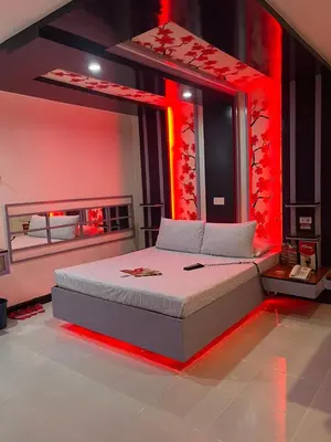 a bedroom with a bed with red lights on it at Hotel Sogo Quirino in Manila