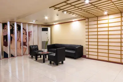 a waiting room with a couch and chairs and a table at Hotel Sogo Kalentong in Manila