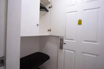 a white door with a black stool in a room at Hotel Sogo Kalentong in Manila